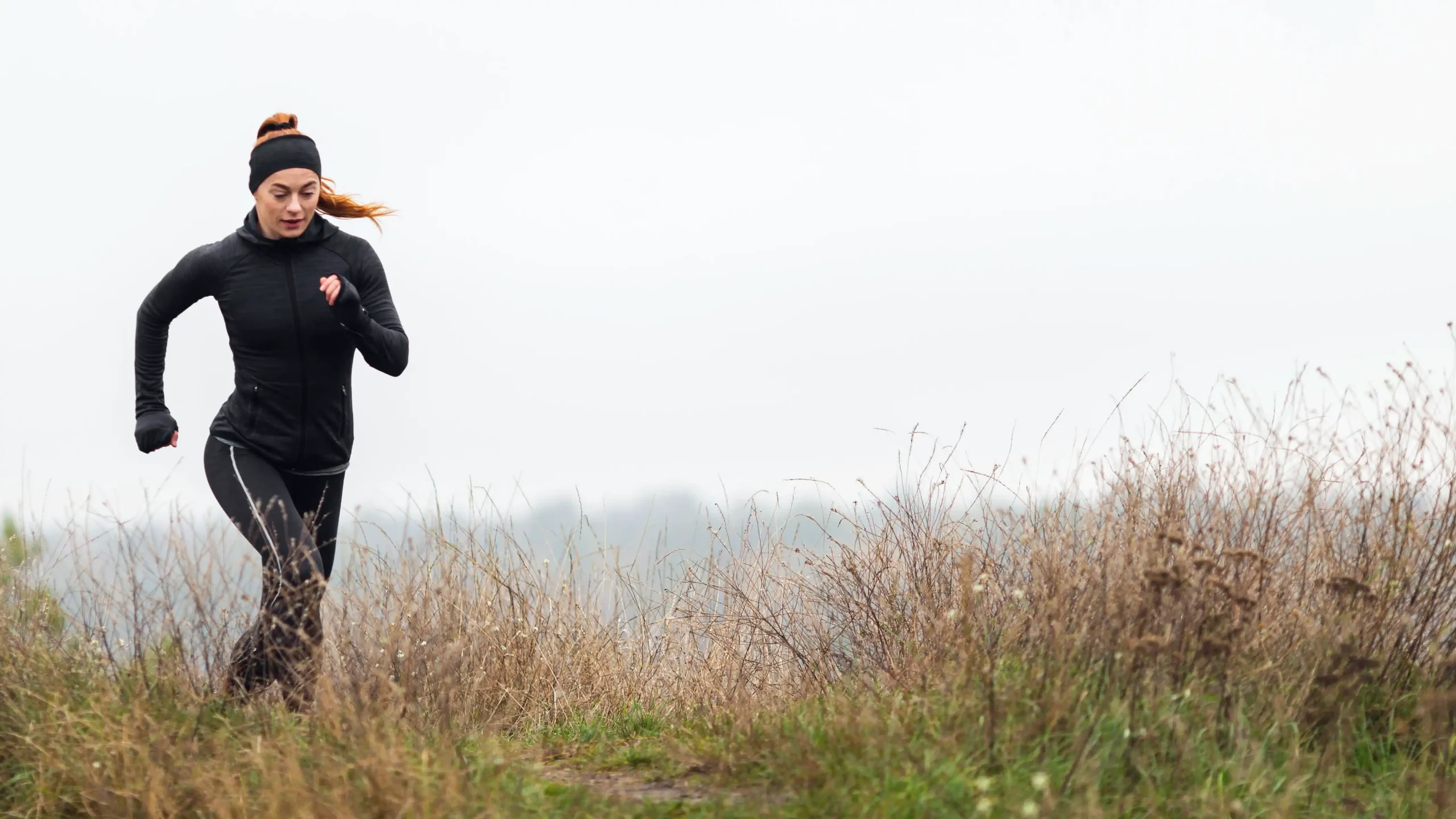 female sporty jogger running outdoors scaled