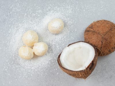 Sliced coconut with round sweet cookies on white background. High quality photo